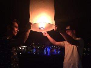 The boys launch a fire lantern in preparation for New Year's Eve in Pai, Thailand.