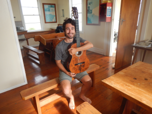 Lindsay with his guitar at Cape Brett hut.