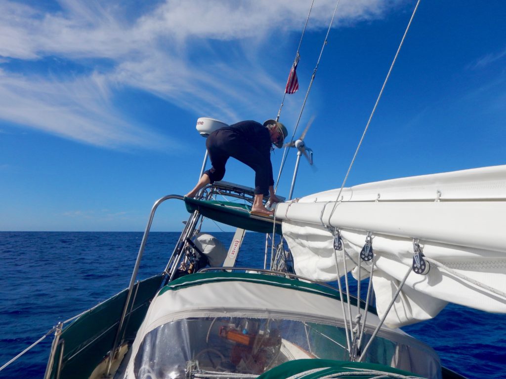 Topping lift repair on the high seas.  We waited for conditions to settle before attempting this high-wire act. 